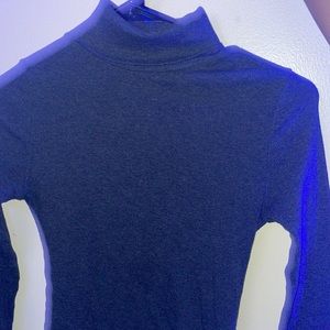 Grey turtleneck, medium size, ambiance branded.